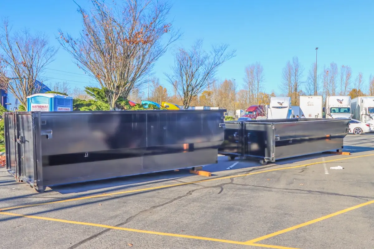 Professional dumpster rental service with roll-off container on residential driveway in Rochester